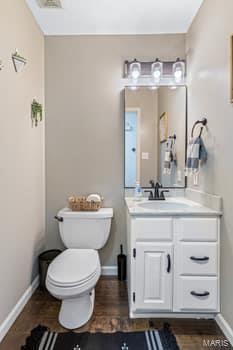 825 Cimarron Cir, Farmington, MO 63640 - bathroom with vanity, toilet, and baseboards