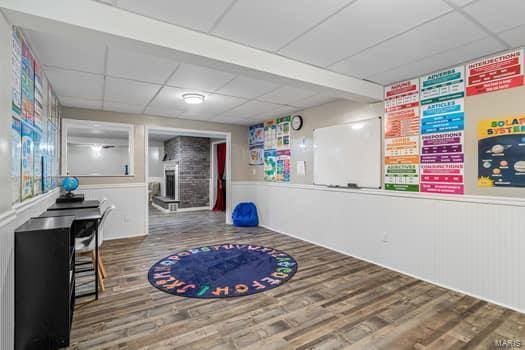 825 Cimarron Cir, Farmington, MO 63640 - exercise area featuring a paneled ceiling, wood finished floors, wainscoting, and a community bar