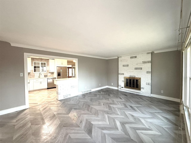 5011 Courtside Dr, Imperial, MO 63052 - unfurnished living room featuring baseboards, crown molding, and a large fireplace