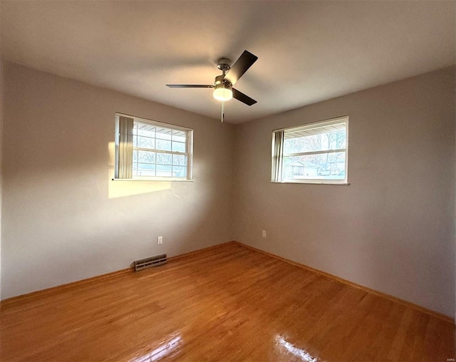 5011 Courtside Dr, Imperial, MO 63052 - spare room with light wood finished floors, plenty of natural light, a ceiling fan, and baseboards