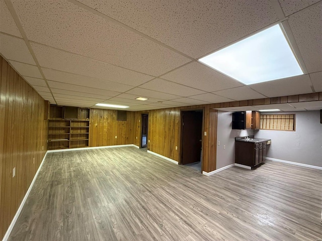 5011 Courtside Dr, Imperial, MO 63052 - finished below grade area featuring wooden walls, baseboards, light wood-style floors, and a paneled ceiling