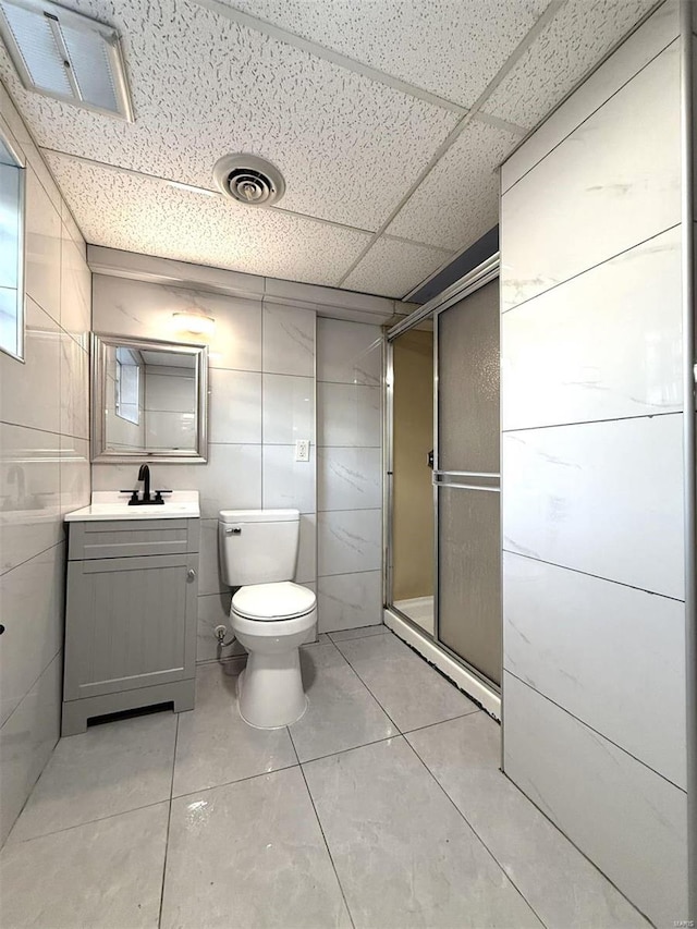 5011 Courtside Dr, Imperial, MO 63052 - bathroom with a stall shower, vanity, toilet, a paneled ceiling, and tile patterned floors