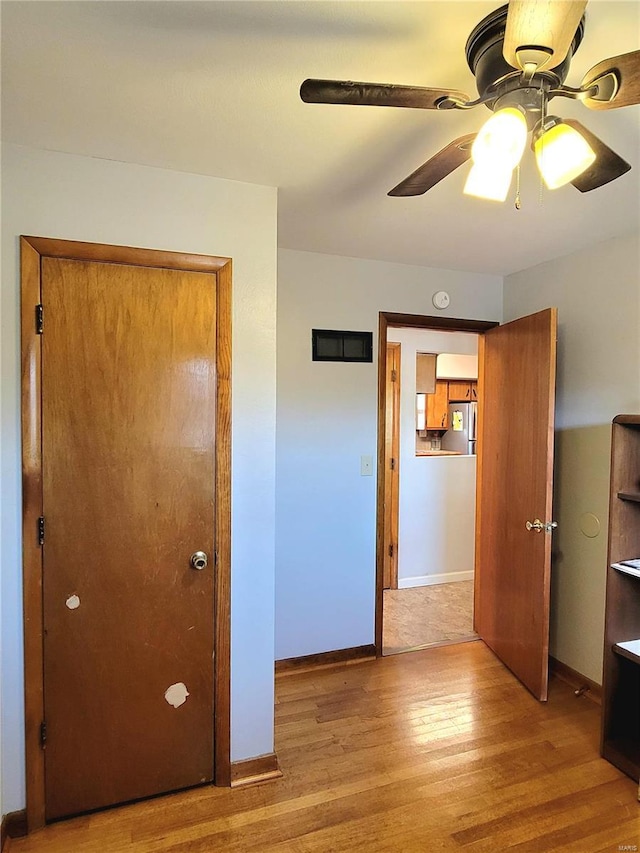 623 E 8th St, Washington, MO 63090 - unfurnished bedroom with light wood finished floors, baseboards, and a ceiling fan