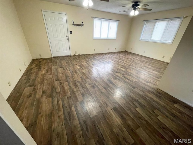 unfurnished living room featuring a ceiling fan and wood finished floors