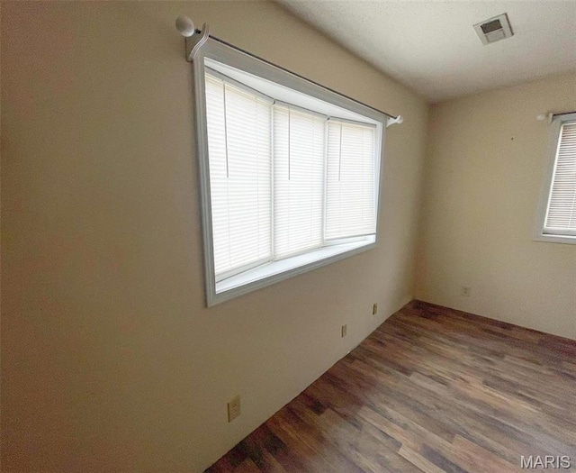 empty room with wood finished floors