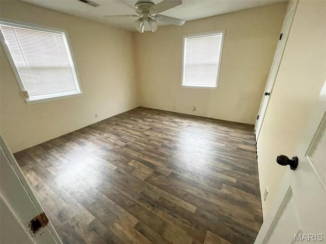 spare room featuring wood finished floors and a ceiling fan