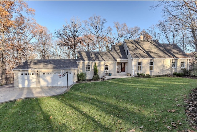 view of front of home featuring concrete driveway, a garage, a front yard, and a chimney