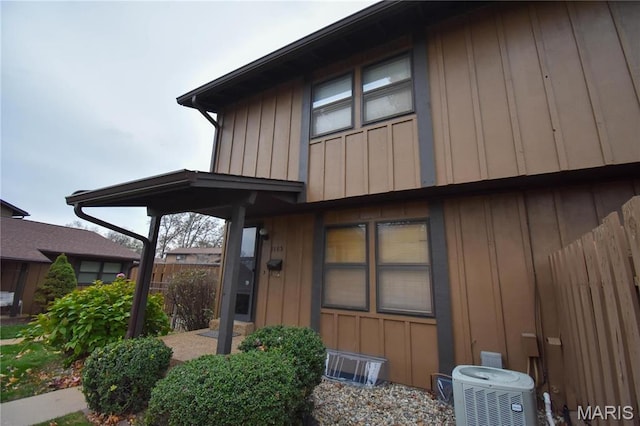 1103 Hampton Ct, Belleville, IL 62223 - view of side of property with cooling unit, fence, and board and batten siding