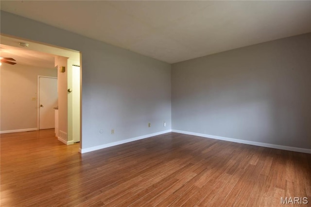 1103 Hampton Ct, Belleville, IL 62223 - unfurnished room with wood finished floors, baseboards, and ceiling fan