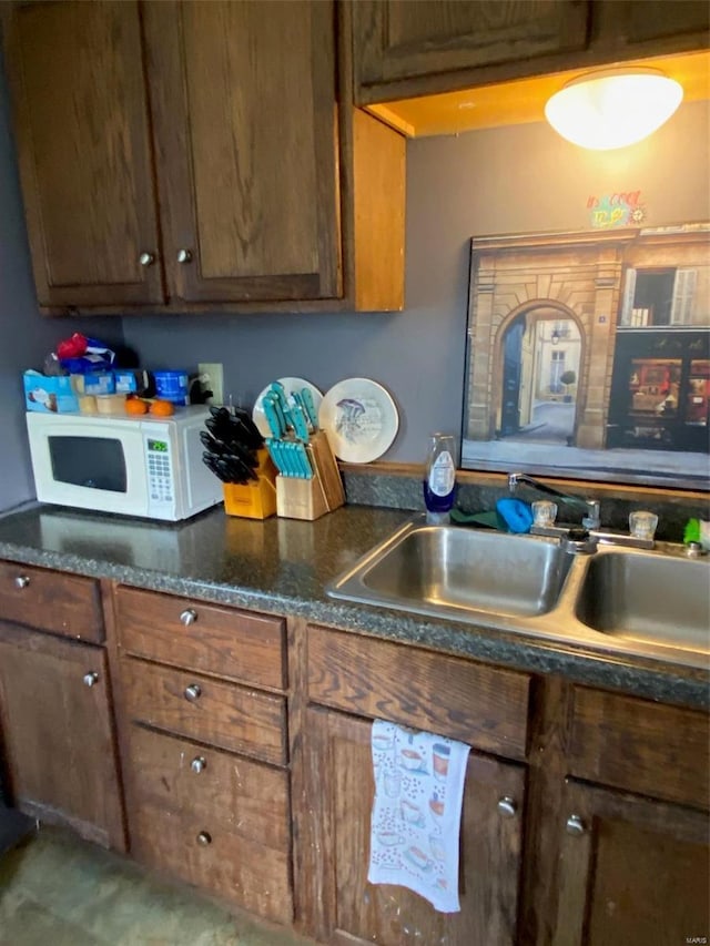 kitchen with white microwave and a sink