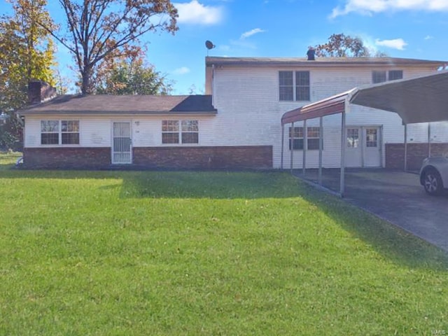 view of front of house featuring a front lawn, driveway, a carport, and brick siding