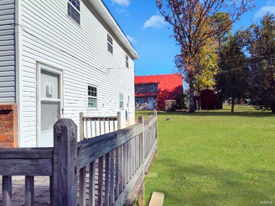 view of side of property with a yard