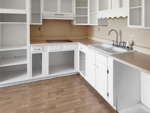 kitchen featuring under cabinet range hood, open shelves, black electric stovetop, white cabinetry, and light wood-style flooring