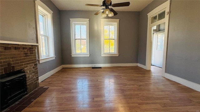 unfurnished dining area featuring wood finished floors, baseboards, and ceiling fan