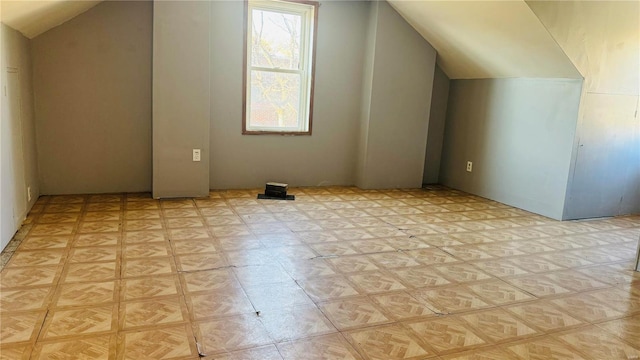 bonus room featuring lofted ceiling and light floors