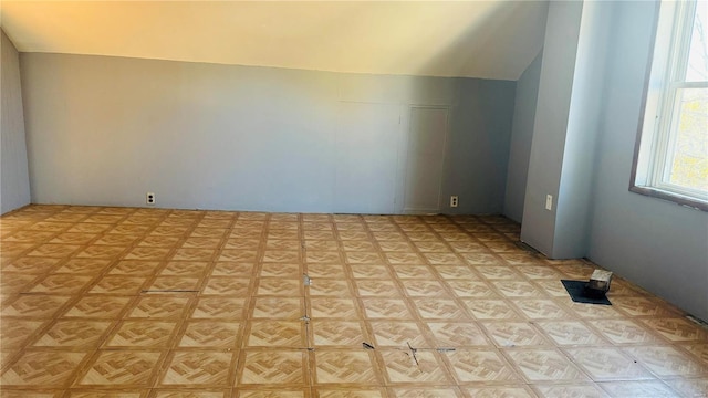 additional living space featuring vaulted ceiling