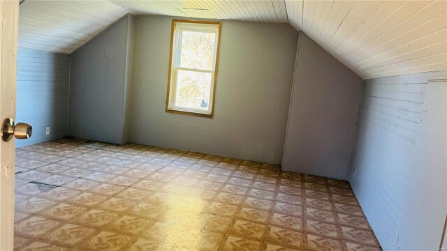 bonus room with vaulted ceiling and light floors