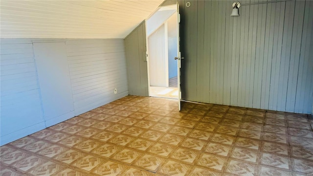 spare room with wood walls