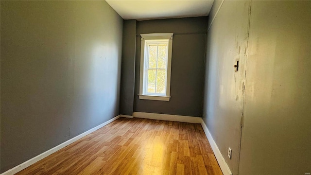 empty room featuring light wood-style flooring and baseboards
