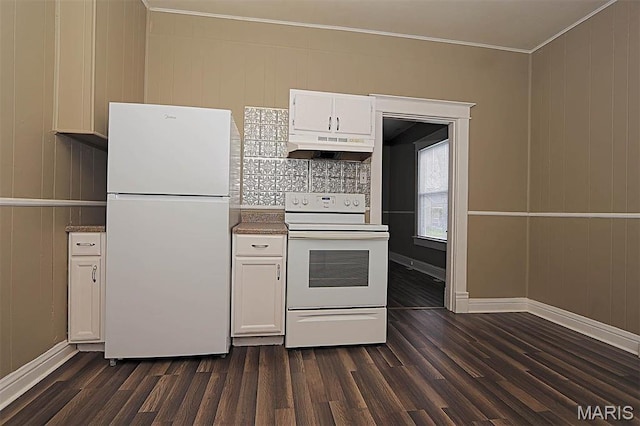kitchen with white appliances, under cabinet range hood, ornamental molding, dark wood-style flooring, and white cabinets