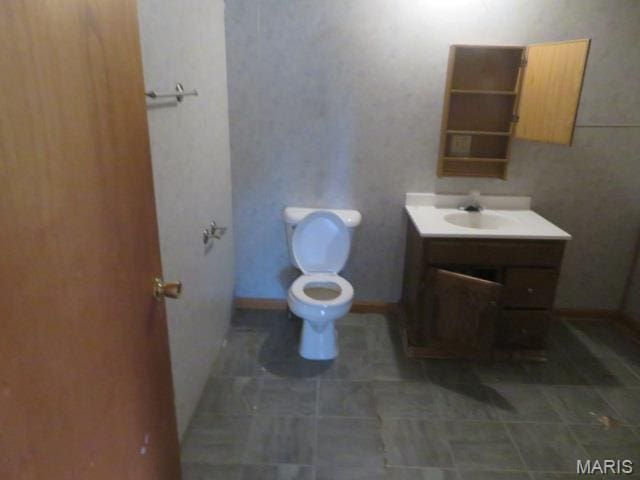 817 S Montgomery Ave, Litchfield, IL 62056 - bathroom with toilet, vanity, and tile patterned floors