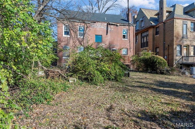 5872 Cabanne Ave, Saint Louis, MO 63112 - back of house featuring a chimney and brick siding