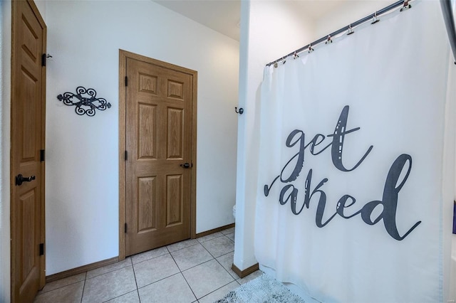 49 Aqua Finn Dr Unit 4A, Lake Ozark, MO 65049 - full bathroom with baseboards, tile patterned floors, and a shower with curtain