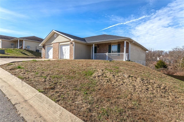 21011 Homer Rd Unit A & B, Saint Robert, MO 65584 - single story home with a porch, brick siding, an attached garage, and driveway