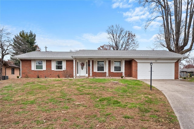649 Springdale Dr, Belleville, IL 62223 - ranch-style house featuring a garage, driveway, brick siding, and a front lawn