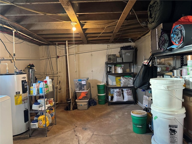 unfinished basement featuring water heater and washer / dryer