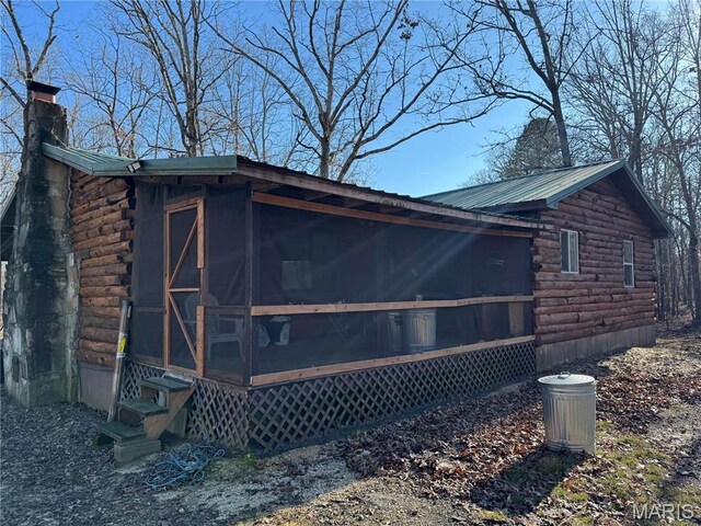 839 Bluebird Ln, Doniphan, MO 63935 - view of side of property featuring log exterior, a sunroom, a chimney, and entry steps