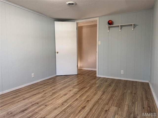 839 Bluebird Ln, Doniphan, MO 63935 - unfurnished bedroom with wood finished floors, a textured ceiling, and baseboards