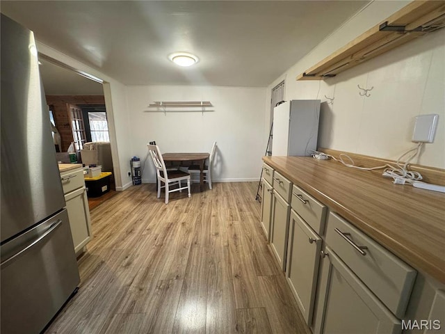 839 Bluebird Ln, Doniphan, MO 63935 - kitchen featuring freestanding refrigerator, butcher block countertops, light wood-style floors, and gray cabinetry