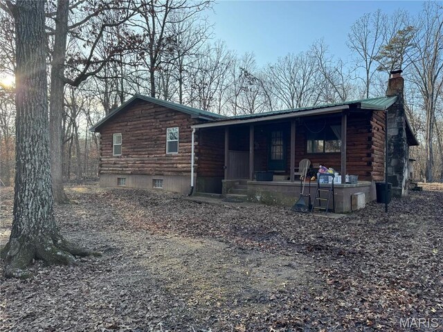 839 Bluebird Ln, Doniphan, MO 63935 - back of property featuring log exterior, covered porch, a chimney, and metal roof