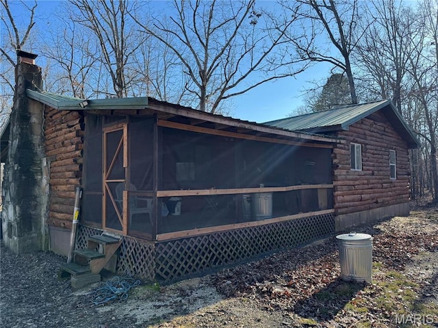 839 Bluebird Ln, Doniphan, MO 63935 - view of side of property featuring log exterior, a sunroom, a chimney, and entry steps