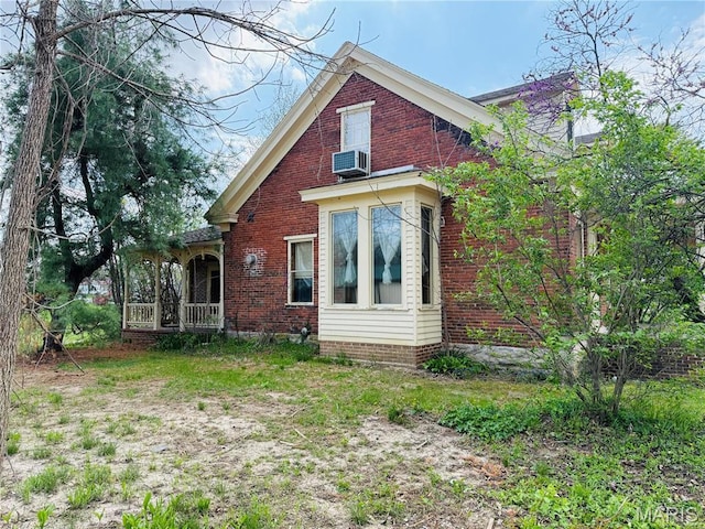 315 E Madison St, Paris, MO 65275 - rear view of house with brick siding, covered porch, and cooling unit