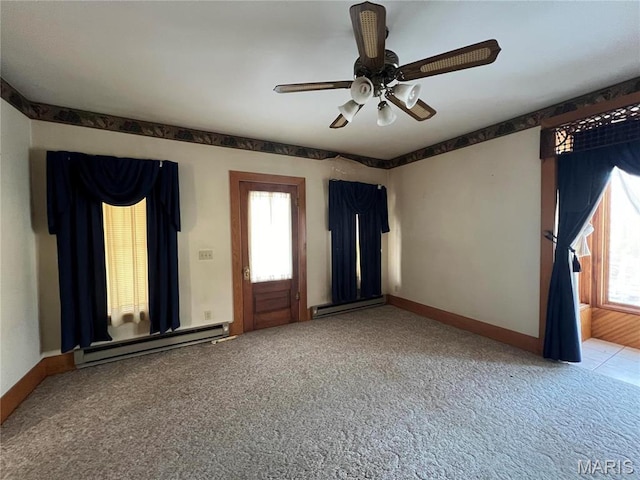 315 E Madison St, Paris, MO 65275 - carpeted empty room featuring a baseboard heating unit, healthy amount of natural light, and ceiling fan