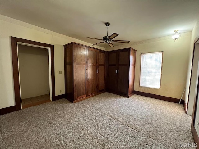 315 E Madison St, Paris, MO 65275 - unfurnished bedroom with light carpet, baseboards, and a ceiling fan