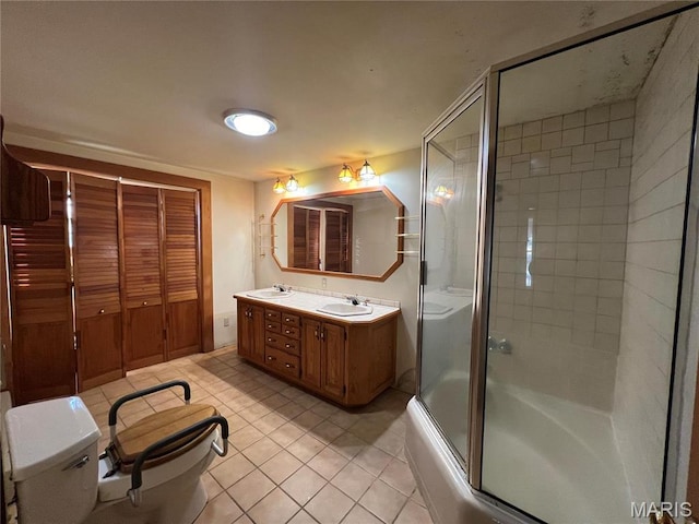 315 E Madison St, Paris, MO 65275 - bathroom featuring toilet, tile patterned flooring, double vanity, and shower / bath combination with glass door