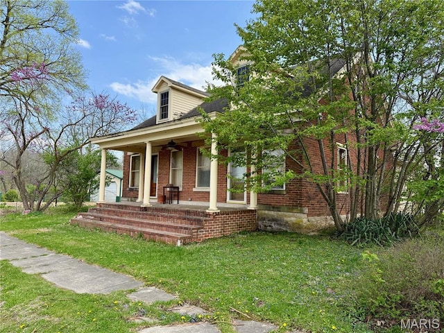 315 E Madison St, Paris, MO 65275 - view of front of home featuring covered porch, a front lawn, and brick siding