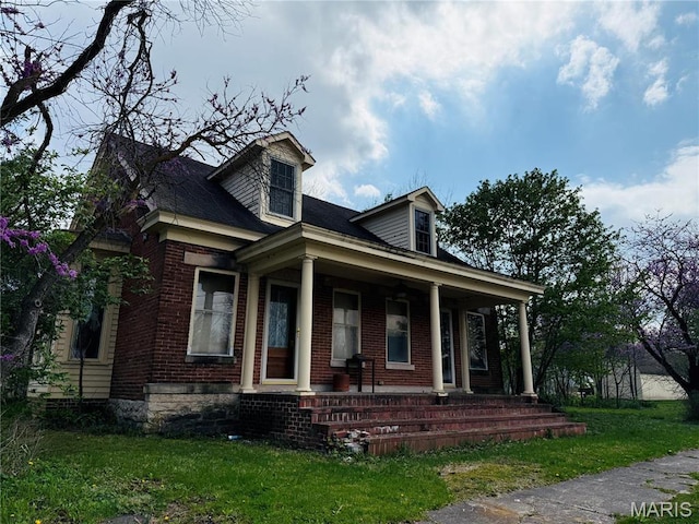315 E Madison St, Paris, MO 65275 - view of front of home with covered porch, brick siding, and a front lawn