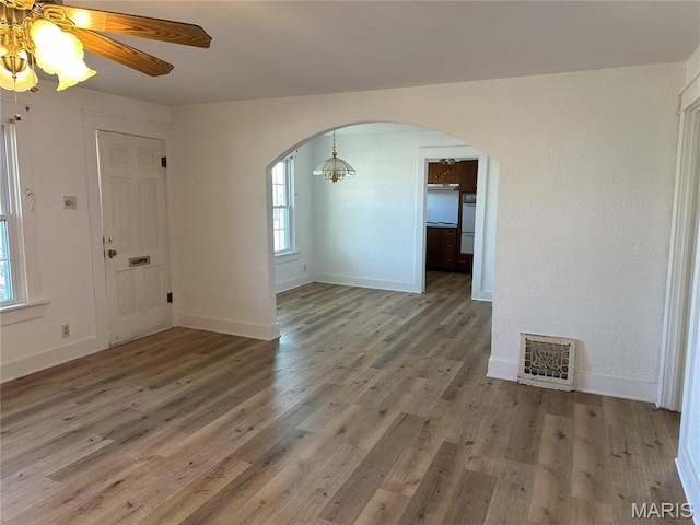 607 S Mcarthur St, Salem, MO 65560 - spare room with arched walkways, wood finished floors, and a ceiling fan