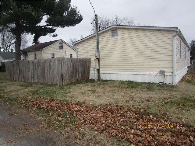 view of side of home featuring fence