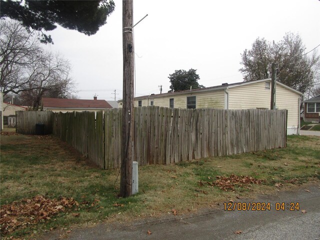 view of side of home featuring fence