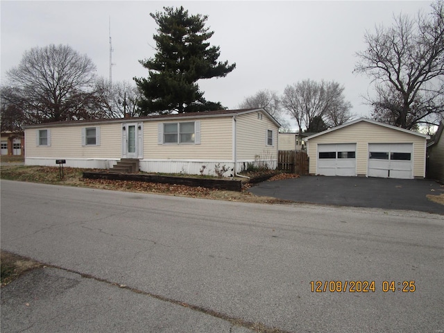 manufactured / mobile home featuring entry steps, a detached garage, and an outbuilding