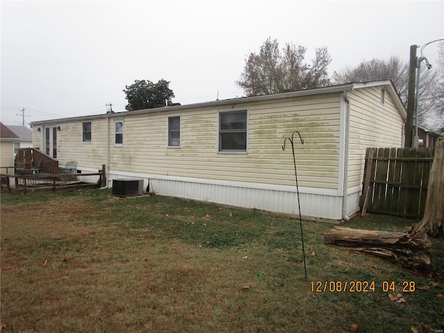 rear view of house featuring central AC unit