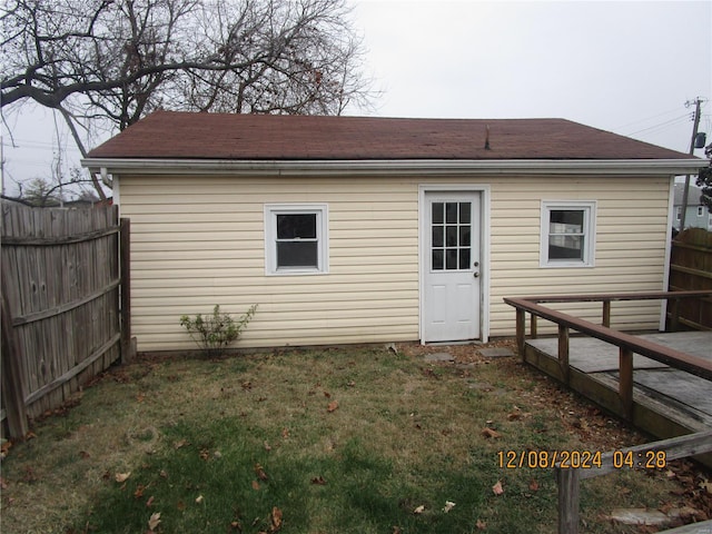 rear view of property with roof with shingles