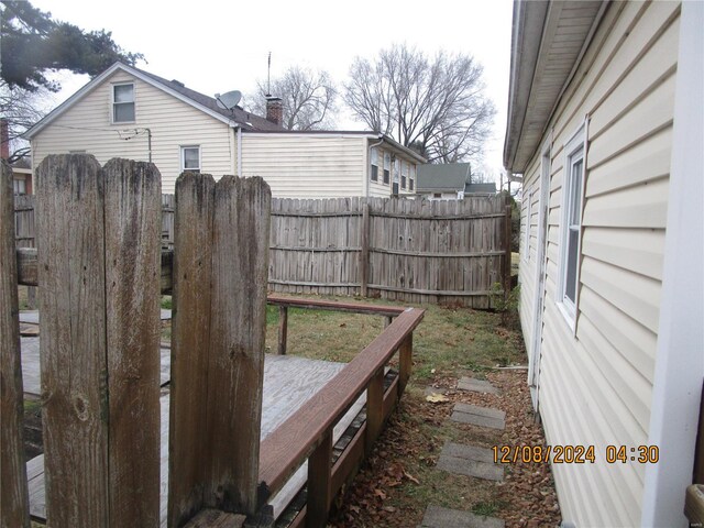 view of yard featuring fence and a wooden deck