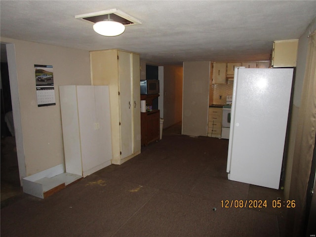 kitchen with white appliances and cream cabinetry