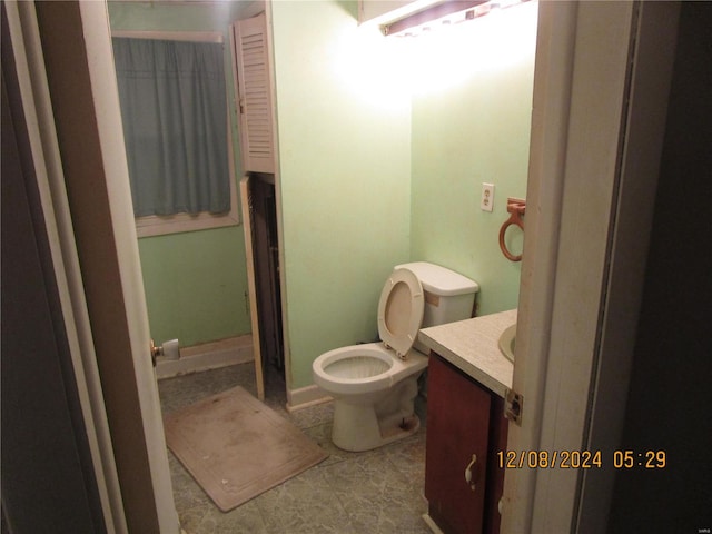 bathroom featuring toilet and vanity